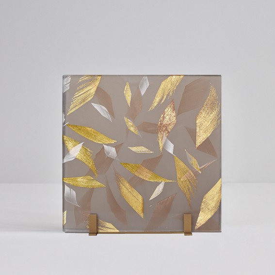 Architectural feather glass. Smoked glass laminated with gold and white feathers.