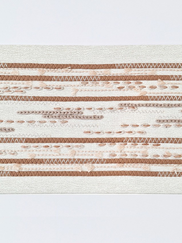 P+L Studio embroidery, handmade in France, with precise decorative stitching in different textural materials applied in a modern, linear pattern.